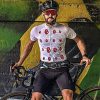 A male cyclist wearing a wulibike cherry mouth white short-sleeved jersey sits on a bike